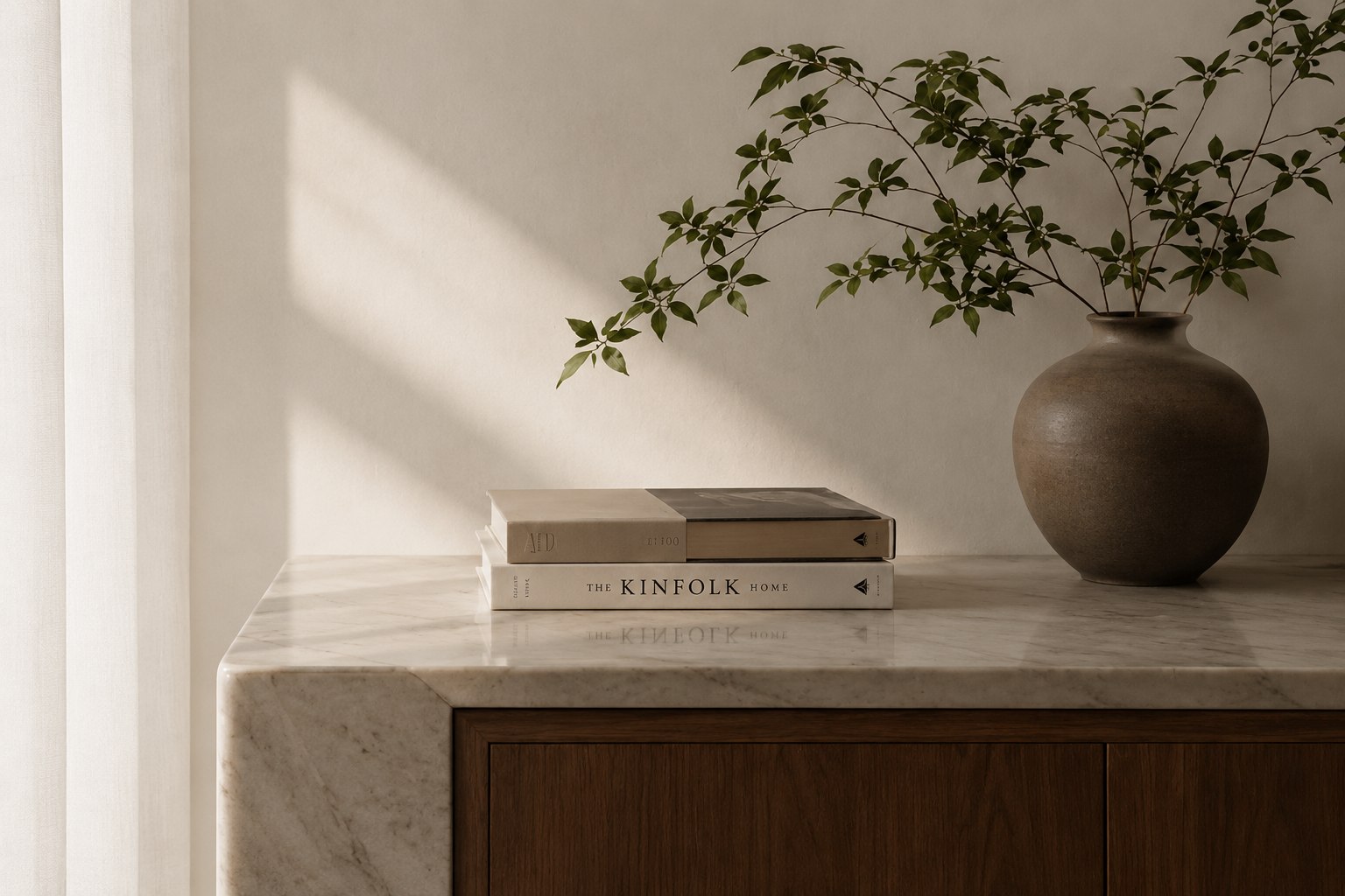 A calm home interior with natural light, books and greenery